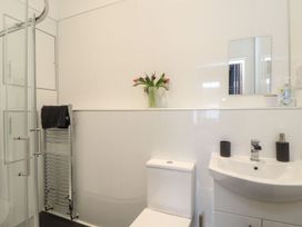 A bathroom with a shower, toilet, and sink at Baker Chambers in Camborne