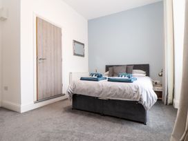A bedroom with a bed and a door at Teylu in Camborne
