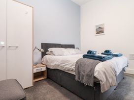 A bedroom with a bed and nightstand at Teylu in Camborne