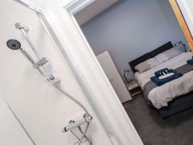 A bathroom with a shower and a bedroom view at Teylu in Camborne
