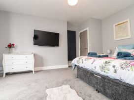 A bedroom with a bed and television at Battell Chambers in Camborne