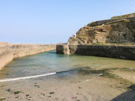 A harbor surrounded by rock cliffs at Battell Chambers Camborne