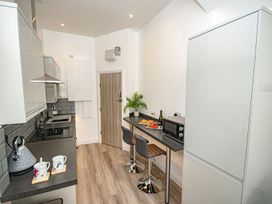 A kitchen with a countertop and bar stools at Daniel Chambers in Camborne