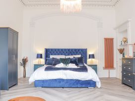 A bedroom with a blue bed and wardrobe at Mews Retreat in Camborne