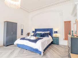 A bedroom with a bed and wardrobe at Mews Retreat in Camborne