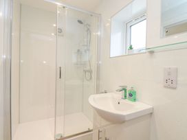 A bathroom with a shower and sink at Mews Retreat in Camborne