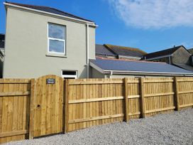 A house with a wooden gate and fence at Mews Retreat in Camborne