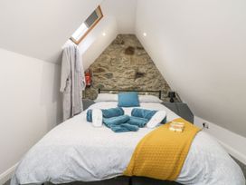 A bedroom with a bed and towels on it at The Snug in Camborne