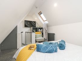 A bedroom with a bed and television at The Snug in Camborne