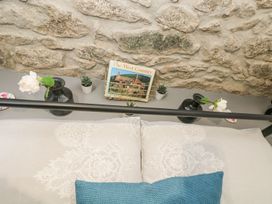 A bedroom with a bed and decorative items at The Snug in Camborne