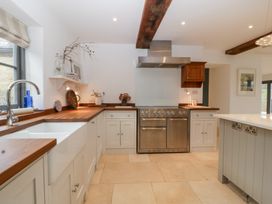 A kitchen with a sink and stove at Spring View in Tetbury
