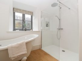 A bathroom with a bathtub and shower enclosure at Spring View in Tetbury