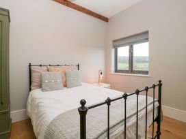 A bedroom with a bed and bedside lamp at Spring View in Tetbury