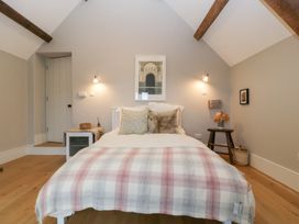 A bedroom with a bed and artwork on the wall at Spring View in Tetbury