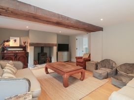 A living room with a sofa and coffee table at Spring View in Kingscote, Gloucestershire