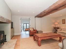 A living room with a sofa and coffee table at Spring View in Kingscote, Gloucestershire