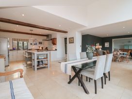 A kitchen and dining area with a table and chairs at Spring View in Kingscote, Gloucestershire