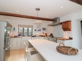 A kitchen with modern appliances and a countertop at Spring View in Kingscote, Gloucestershire