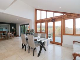 A dining room with a table and chairs at Spring View in Kingscote, Gloucestershire