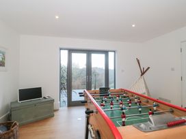 A game room with a foosball table and a television at Spring View in Kingscote, Gloucestershire