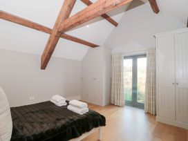 A bedroom with a bed and towels on it at Spring View in Kingscote, Gloucestershire