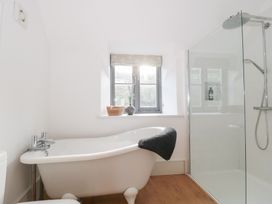A bathroom with a bathtub and shower at Spring View in Kingscote, Gloucestershire