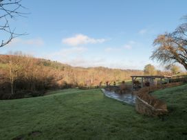 A garden with patio and trees at Spring View in Kingscote, Gloucestershire