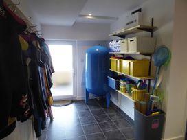 A utility room with storage and wet suits at Gilfach Goed Pwllheli
