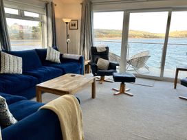 A living room with a view of water at Gilfach Goed in Abersoch