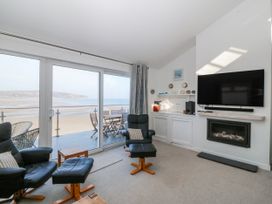 A living room with a view of the beach at Gilfach Goed in Abersoch