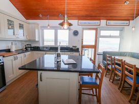 A kitchen with a countertop and dining area at Gilfach Goed in Abersoch