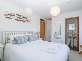 A bedroom with a bed and ensuite bathroom at Gilfach Goed Abersoch