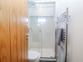 A bathroom with a shower and toilet at Gilfach Goed Abersoch