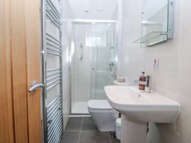 A bathroom with shower, toilet, and sink at Gilfach Goed in Abersoch