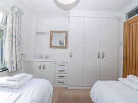 A bedroom with a bed and wardrobe at Gilfach Goed, Abersoch