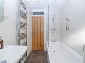 A bathroom with a bathtub and shower fixtures at Gilfach Goed in Abersoch