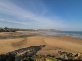 A beach with sand and water at Gilfach Goed in Abersoch