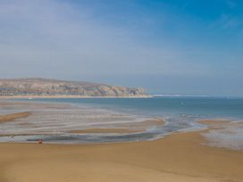 A beach scene with sand and sea at Gilfach Goed in Abersoch