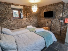 A bedroom with two beds and a television at Gwyn Studio in Aberdare