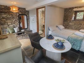 A studio with a bed and dining area in Gwyn Studio Aberdare