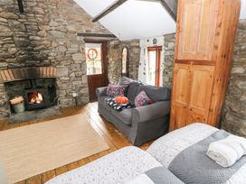 A living room with a fireplace and sofa at Glas Studio in Aberdare