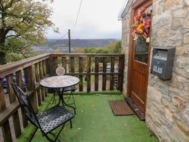 An outdoor seating area with a table and chair at Glas Studio in Aberdare