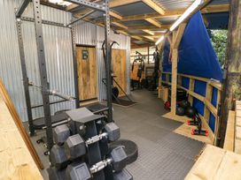 A gym with weights and exercise equipment at Glas Studio in Aberdare