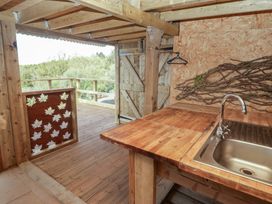 A kitchen with wooden countertops and a sink at Glas Studio in Aberdare