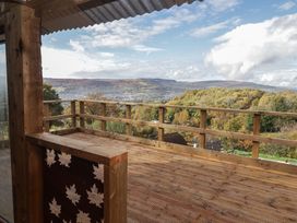 A deck with a view of mountains and trees at Glas Studio in Aberdare