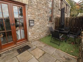 An outdoor seating area with a table and chairs at Arian in Aberdare