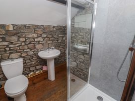 A bathroom with a shower, sink, and toilet at Arian in Aberdare
