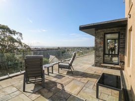 An outdoor terrace with seating and a view at Awelfryn