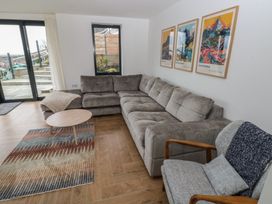 A living room with a sectional sofa and coffee table at Awelfryn 