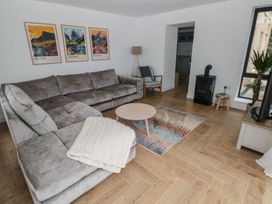 A living room with sofa and coffee table at Awelfryn